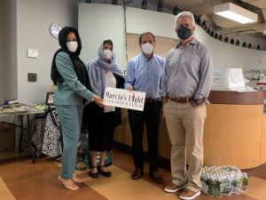 Four people holding a sign for Marcias Light Foundation